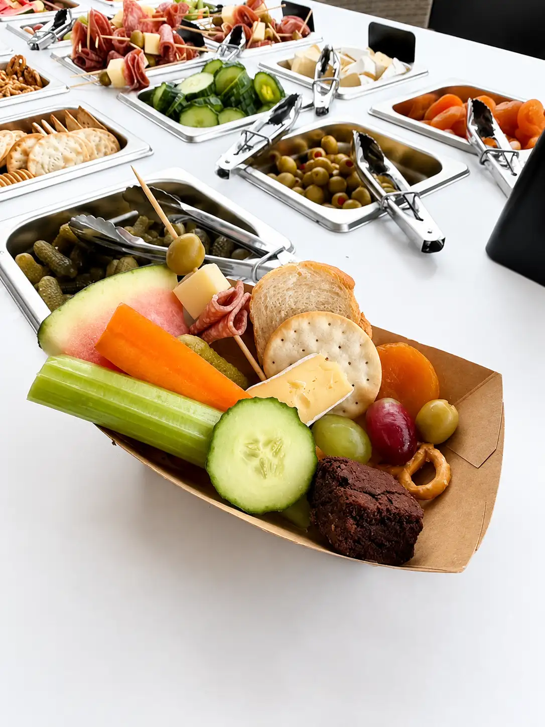 Portrait view of a styled CARTcuterie cart at a coastal gathering